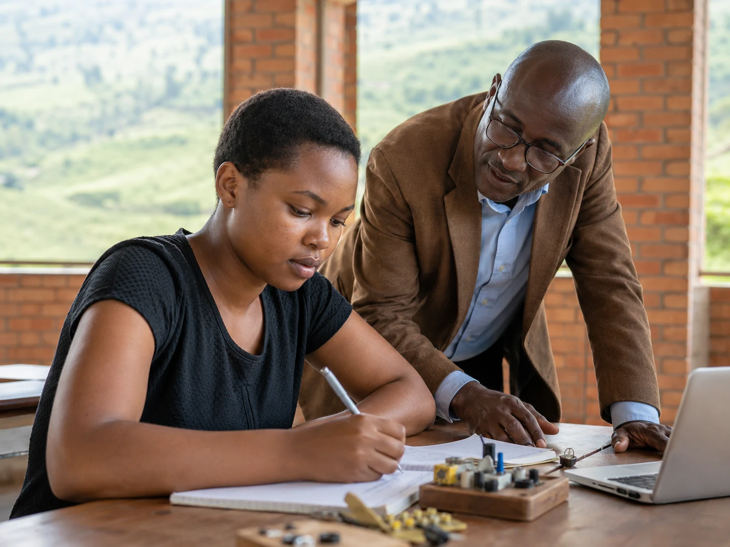 A learner in Rwanda works with an educator through a supported and professionally organised learning pathway.